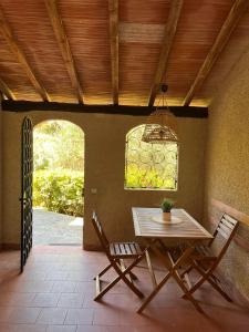 a table and chairs in a patio with a window at La Casina di Checco in Marciana Marina
