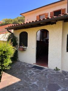 an entry to a house with an open door at La Casina di Checco in Marciana Marina