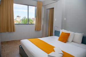 a hotel room with a bed and a window at Mar Azul Suites 5ta Av in Playa del Carmen