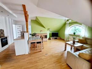 a kitchen and living room with a table and a couch at Apartament Centrum - Giżycko in Giżycko