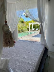 a bedroom with a bed and a view of a pool at Villa zen in Saint-François +31 photos