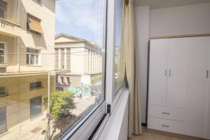 a room with a large window with a view at Facadoro Apartments in Athens
