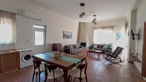 a kitchen and living room with a table and chairs at Dimitra apartment with garden in Kattavia - Prassonisi in Kattavía