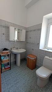a bathroom with a sink and a toilet at Dimitra - Kattavia surf houses in Kattavía
