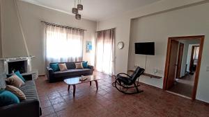 a living room with a couch and a table at Dimitra - Kattavia surf houses in Kattavía +17 photos