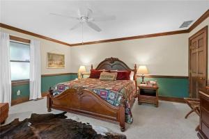 a bedroom with a large bed and a ceiling fan at White River Mountain Manor- Million dollar view in Eureka Springs