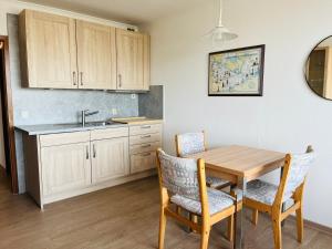 a kitchen with a table and chairs and a sink at Seaview, Beach, Sunsets, Nature in Heiligenhafen
