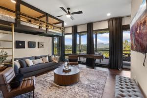 a living room with a couch and a loft bed at High Meadow Retreat in Boone