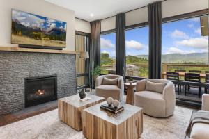 a living room with a fireplace and a tv at High Meadow Retreat in Boone