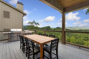 a patio with a wooden table and chairs on a deck at High Meadow Retreat in Boone +52 photos