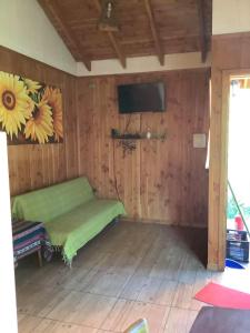 a room with a bed and a flat screen tv at Cabañas Amatista Neltume in Neltume