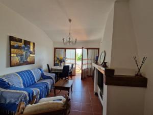 a living room with two couches and a table at Villa Orizzonte in Castelnuovo Berardenga