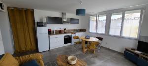 a kitchen with a table and a small kitchen with a table at Les Geais Bleus in Royan