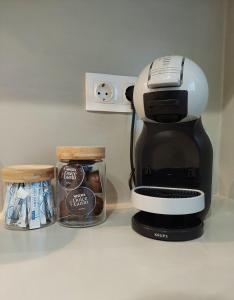 a coffee maker on a counter next to a container of coffee at Josephine's place in Tinos