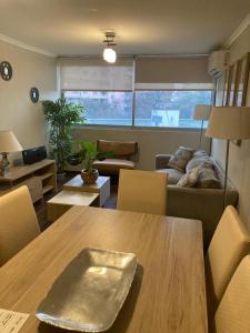 a living room with a table and a couch at M-MONTT Pedro De Valdivia in Santiago