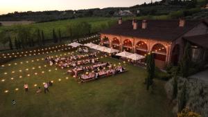 an overhead view of a wedding reception on the lawn of a barn at Il Palazzo - Agriturismo, Winery in Arezzo