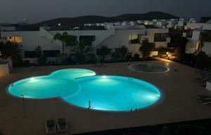 an overhead view of a large swimming pool at night at Casilla de Costa, La Oliva in Villaverde
