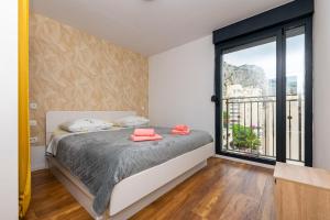 a bedroom with a bed and a large window at Apartment Zdravka in Omiš