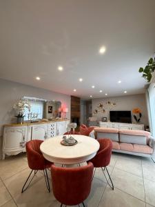 a living room with a table and chairs and a couch at VILLA avec PISCINE PRIVÉE NON PARTAGÉE in Camps-la-Source
