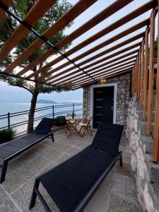 a pergola with two benches and a table on a patio at Apartman Ulrich in Lukovo +11 photos