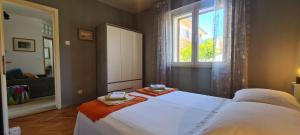 Postel nebo postele na pokoji v ubytování Apartment Bosiljak