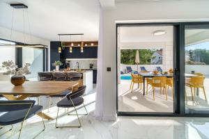 a kitchen and dining room with a table and chairs at Villa Dono in Sutivan +88 photos
