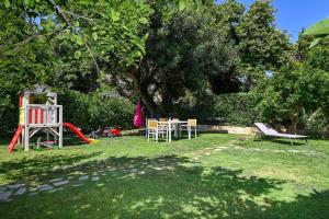 a yard with a playground with a table and chairs at Antonia in Plakias