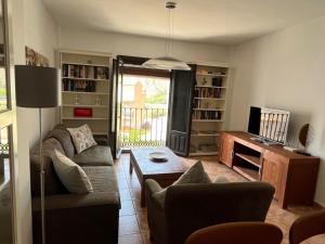 a living room with a couch and a table at La Bicicleta, Duplex en Vélez Benaudalla in Vélez de Benaudalla