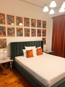 a bedroom with a large bed with orange pillows at 145 Townhouse in Ílhavo