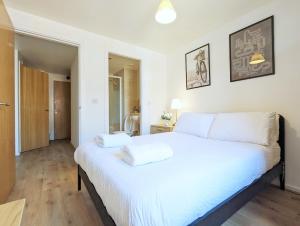 a bedroom with a large white bed with two towels on it at Guest Rooms In City Centre Near Key Attractions in Liverpool