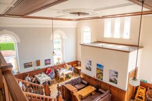a large room with people sitting at tables in it at Pontcysyllte Chapel Tearoom in Llangollen
