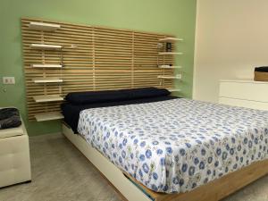 um quarto com uma cama e uma cabeceira em madeira em Casa Dolce Casa - Appartamento a Porto Viro em Porto Viro