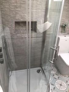 a shower with a glass door in a bathroom at The Croft in Cowbridge