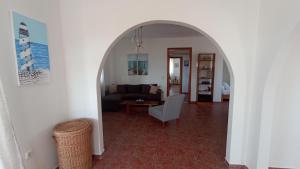 an archway in a living room with a couch at Kristallia apartment with view - Kattavia in Kattavía