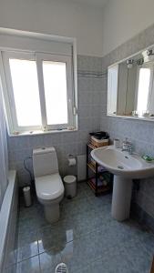 a bathroom with a toilet and a sink at Kristallia apartment with view - Kattavia in Kattavía