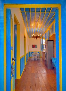 a colorful hallway with a table and chairs at Casa Colonial Salento in Salento