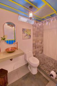 a bathroom with a toilet and a sink and a shower at Casa Colonial Salento in Salento