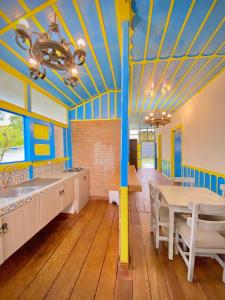 a dining room with blue and yellow ceilings and a table at Casa Colonial Salento in Salento