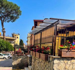 a building with flower boxes on a stone wall at Casa Nennella con Parcheggio Auto gratuito in Loco in Naples