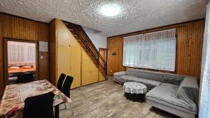 a living room with a couch and a table at Mária 93 in Balatonmáriafürdő