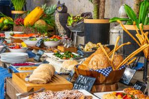 a buffet of bread and other food on a table at GHL Arsenal Hotel in Cartagena de Indias