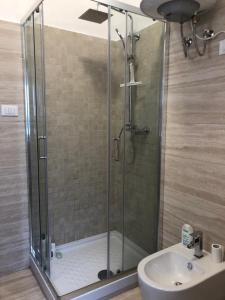 a shower with a glass door next to a sink at Il Rifugio sul Mare in Terme Luigiane +31 photos