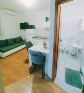 Habitación con mesa y baño con lavabo. en Apartments Jagoda, en Split