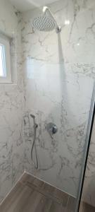 a bathroom with a shower with a glass door at Christinas 3 in Nerántza