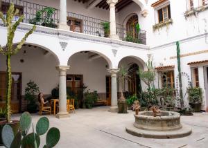 a courtyard in a building with a fountain at Grana B&B in Oaxaca City