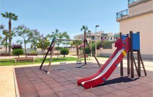 a playground with a red slide in a park at San Jorge Castellon in San Jorge