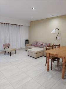 a living room with a couch and a table at RuGra Departamento in Tres Arroyos