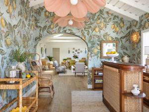 a living room with a floral wallpaper at Farmhouse Paso in Paso Robles