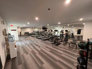 a gym with a bunch of treadmills and chairs at Staybridge Suites - Calgary Airport, an IHG Hotel in Calgary