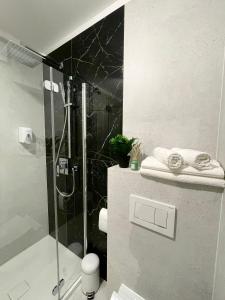 a bathroom with a shower with a glass door at K&M Apartament Panorama in Bochnia